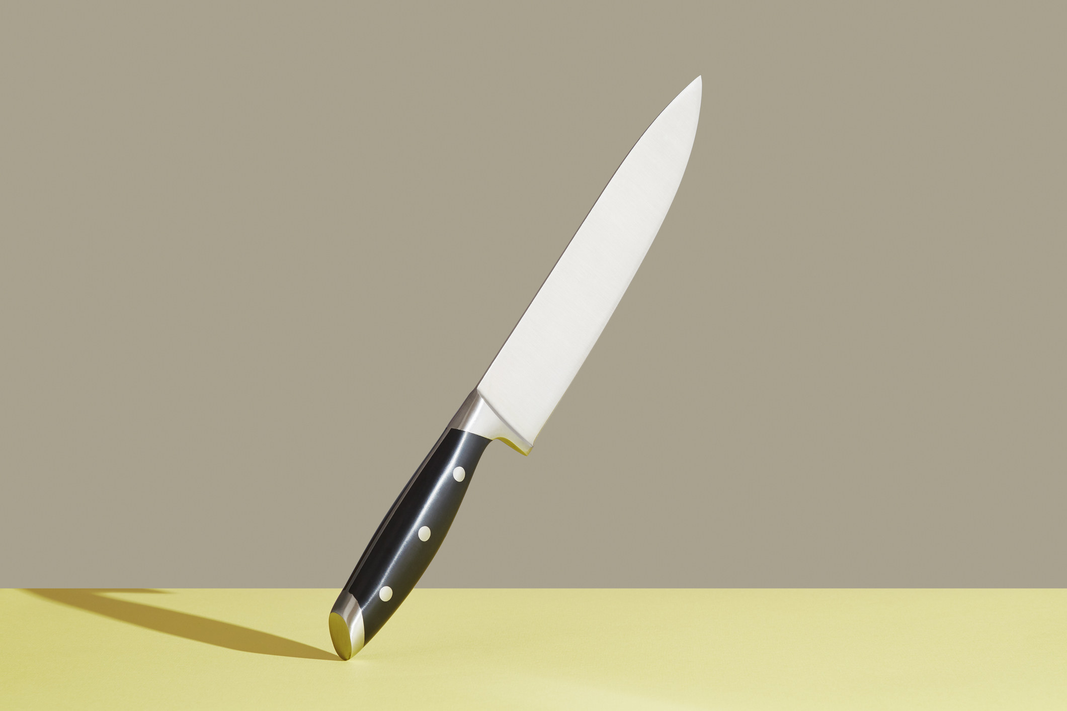 A knife resting on its handle.