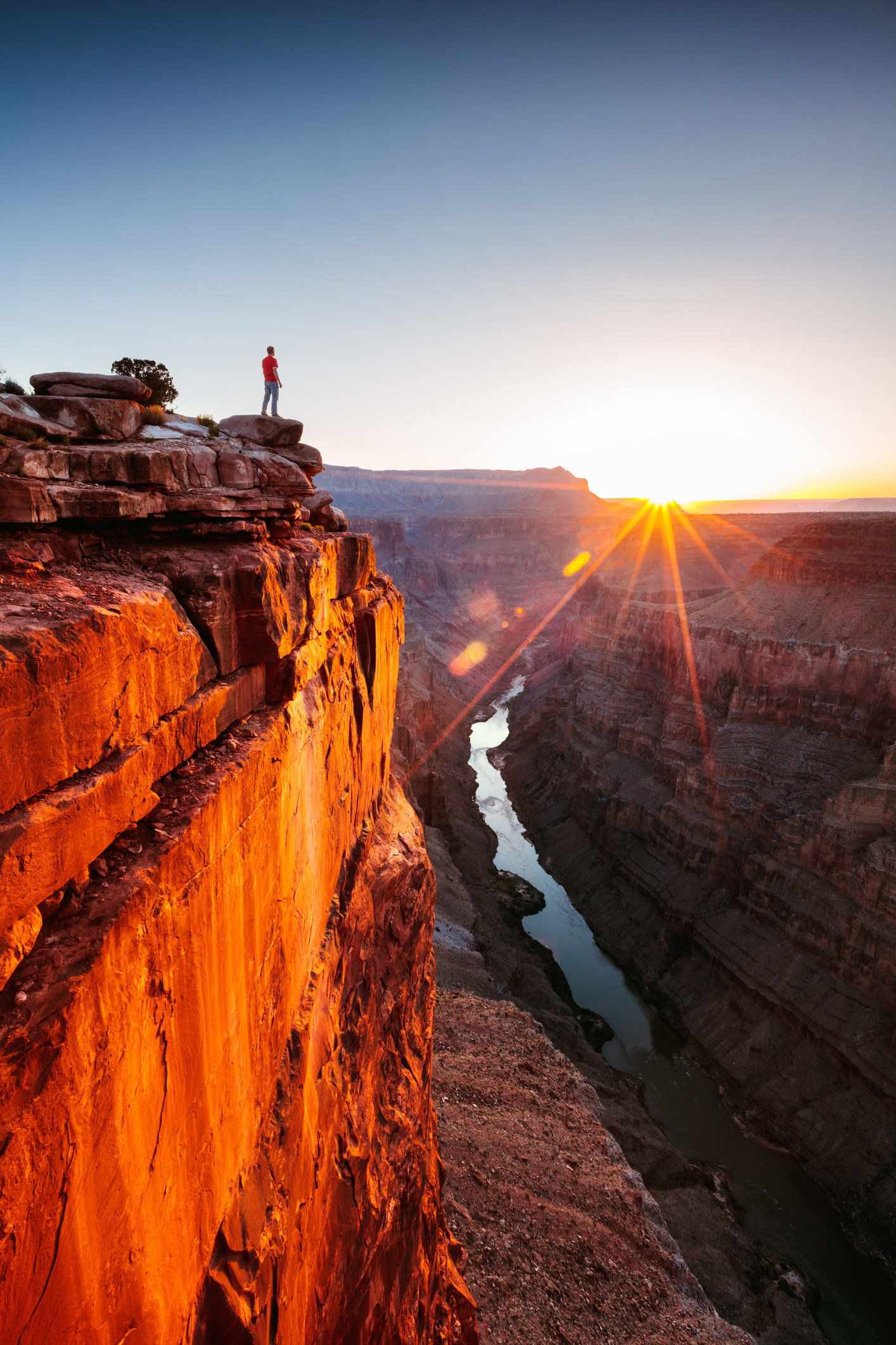 A man standing at the rim of the Grand Canyon.