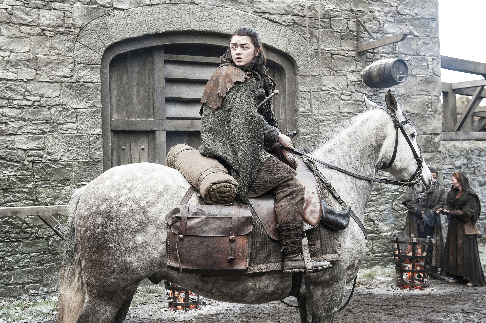 Maisie looks backwards while sitting on a horse