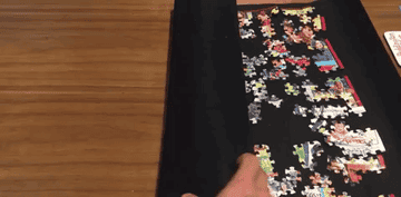 Reviewer&#x27;s gif of them unrolling the puzzle mat