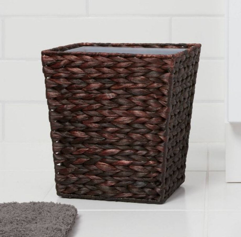 A dark woven wastebasket