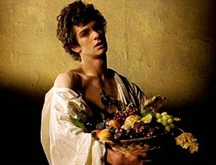 Andrew Garfield holds a basket of fruit