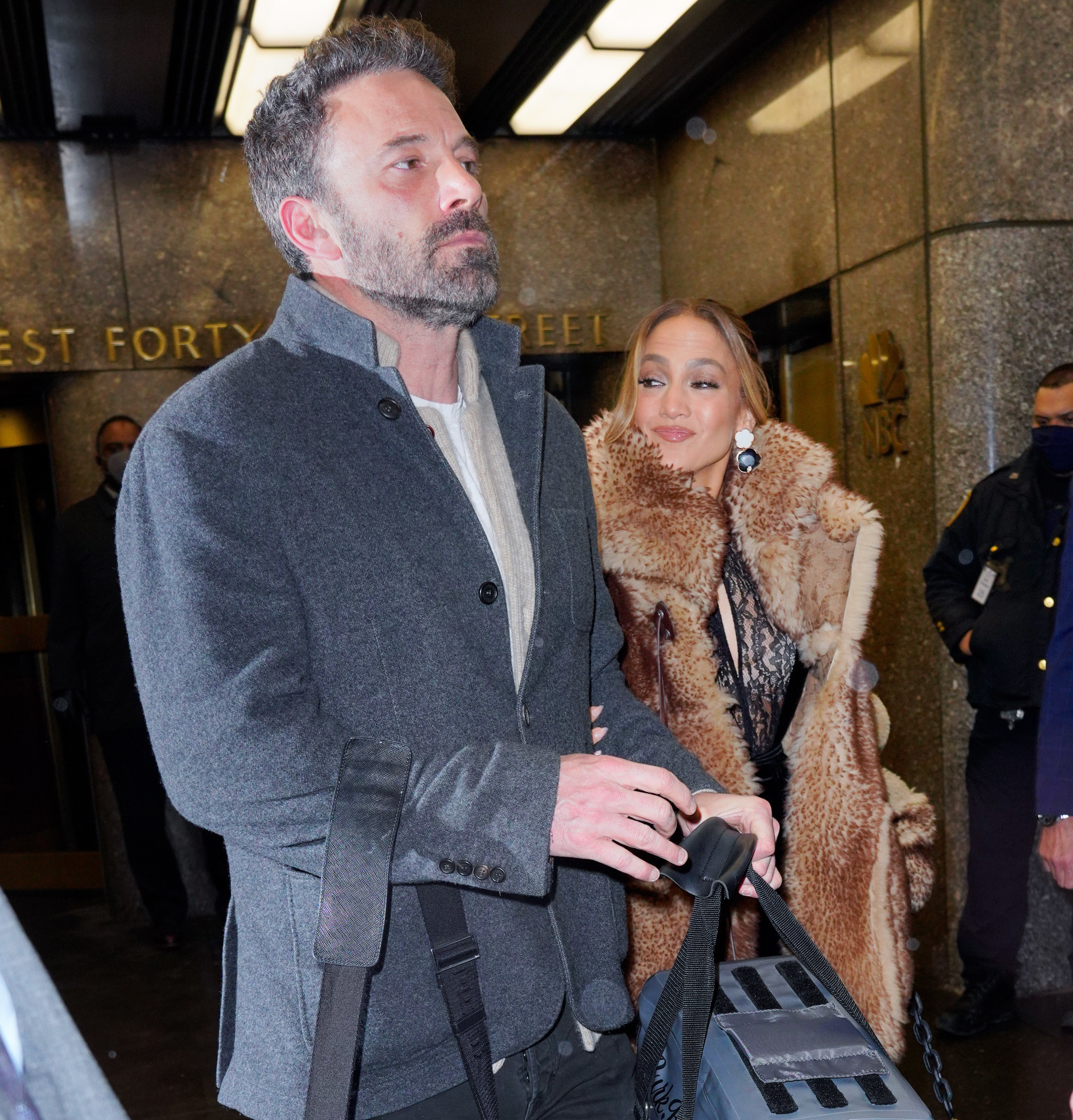 Ben and Jennifer walk out of a building