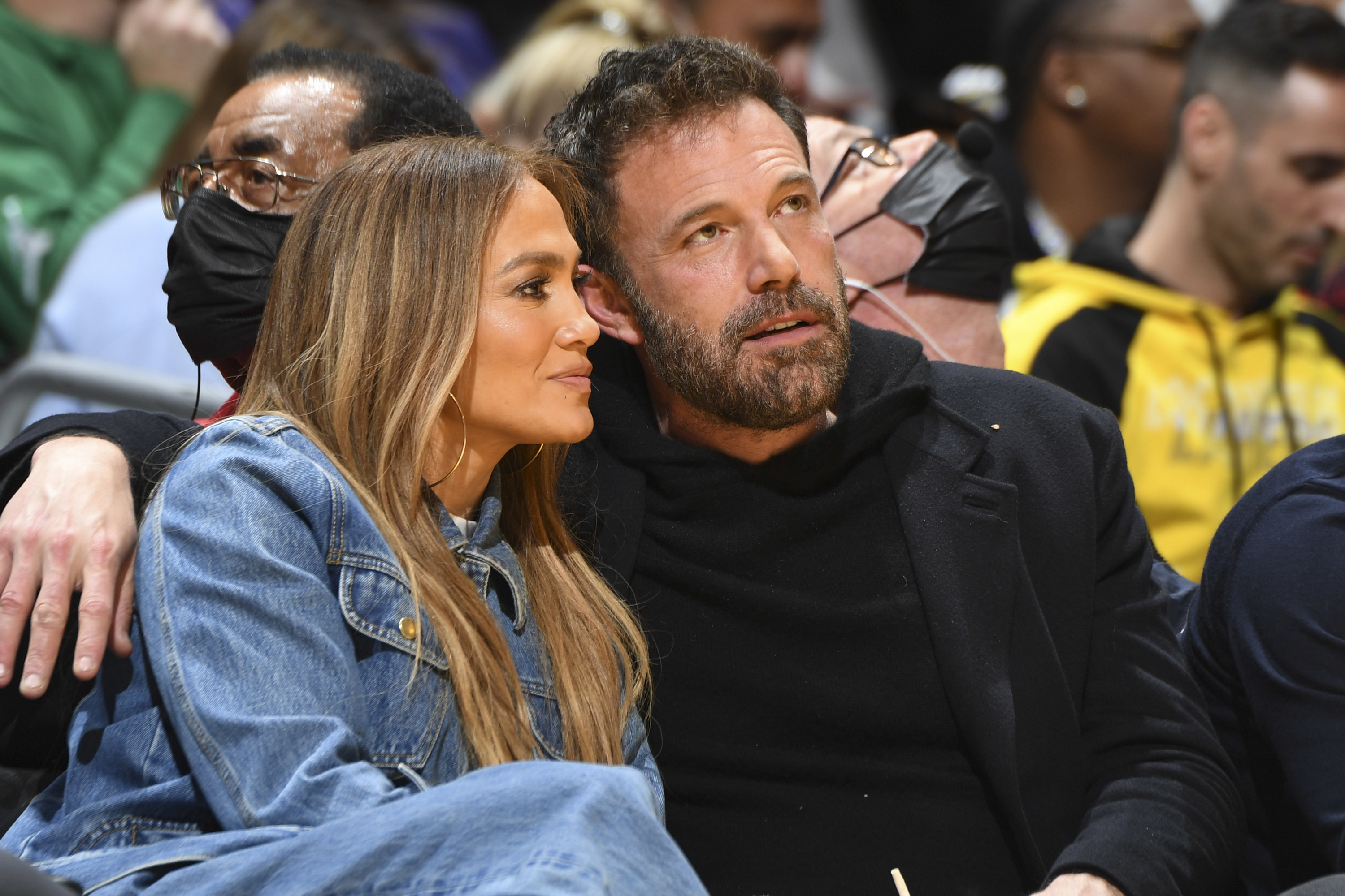 Jennifer and Ben sit next to each other at a basketball game