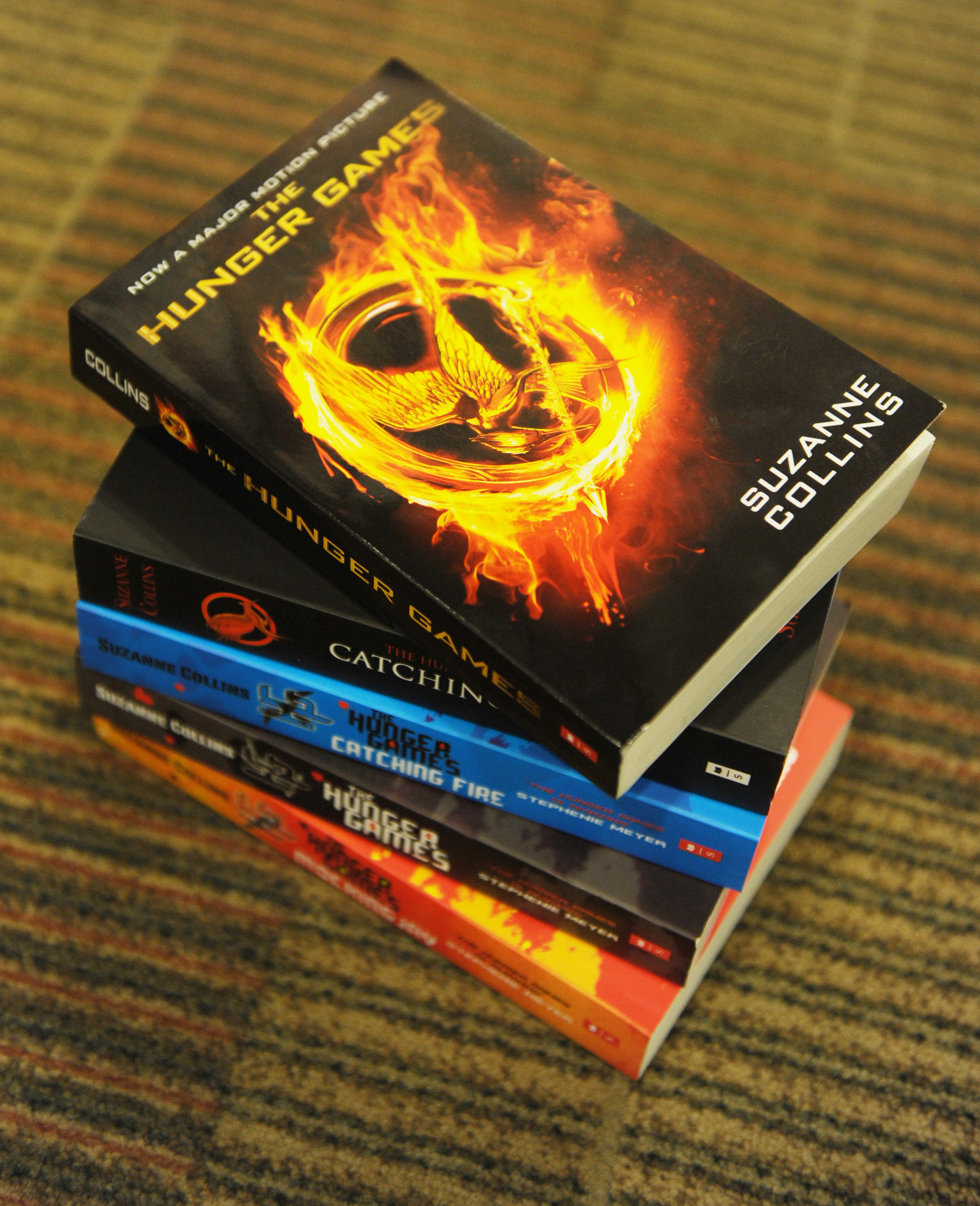 The three books in the Hunger Games trilogy stacked on top of each other