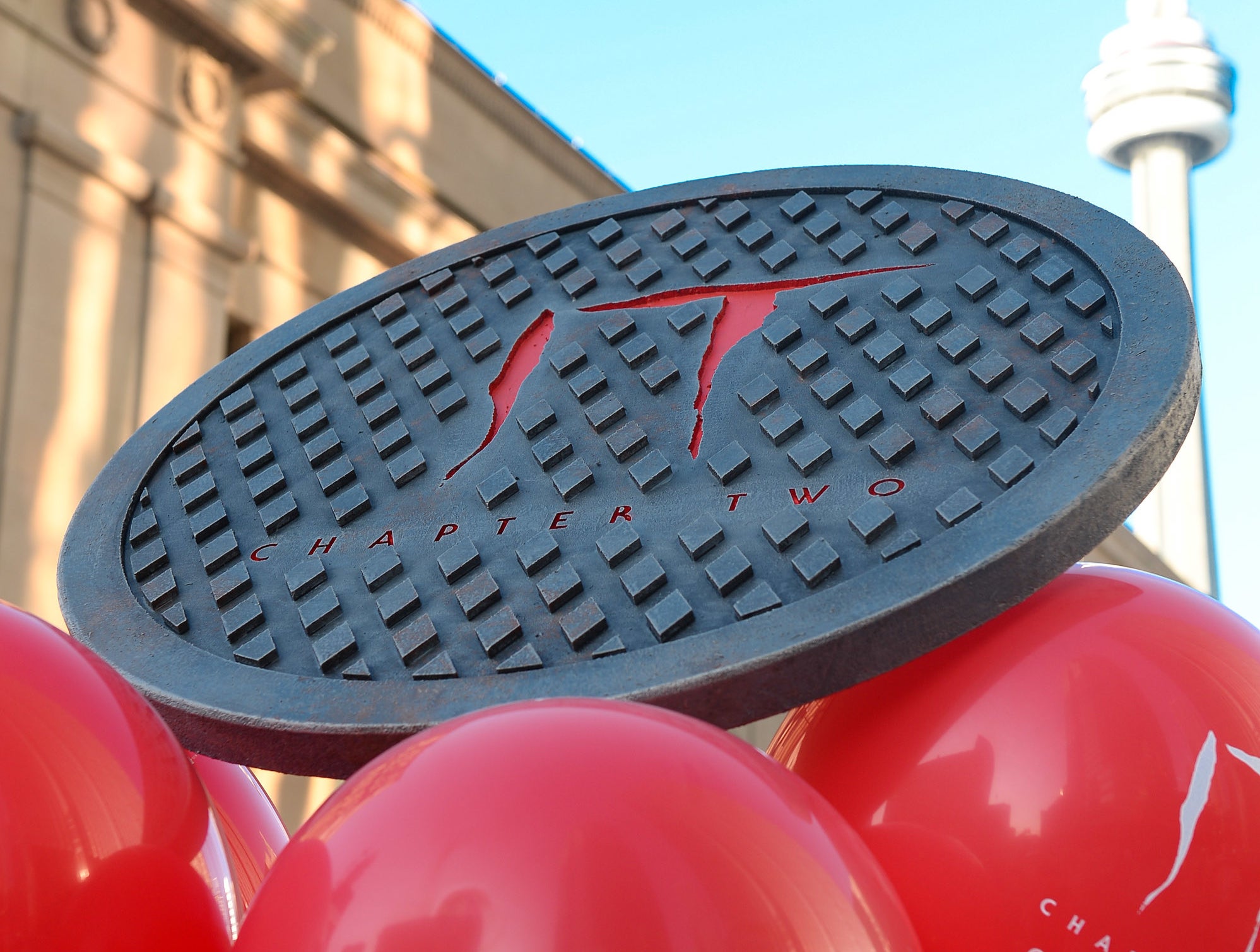 A manhole cover floating on top of balloons as advertising for IT: Chapter Two