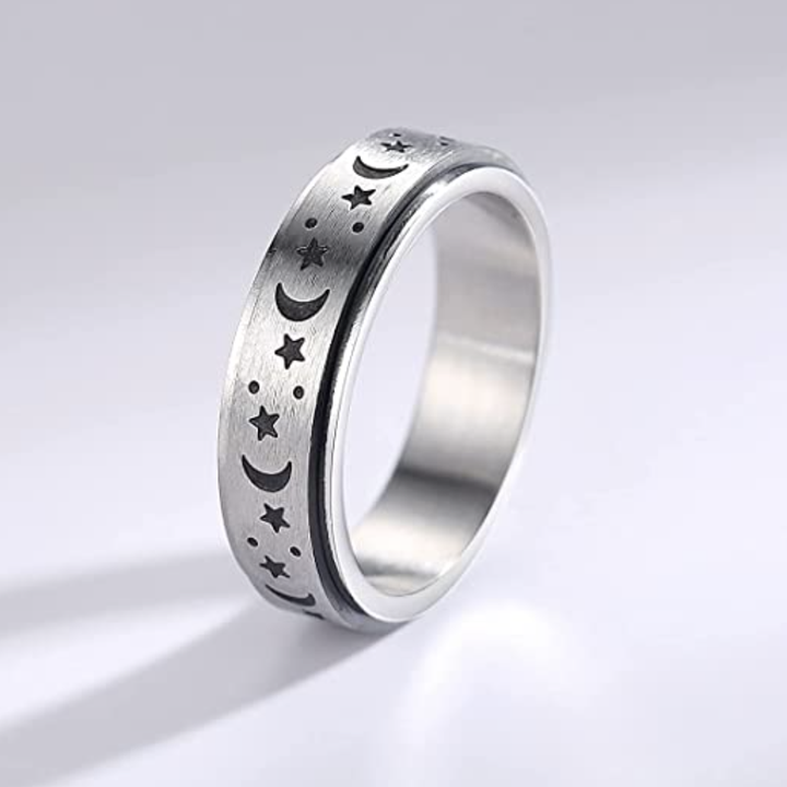 One of the spinning rings, with moons and stars, standing vertically against a neutral background