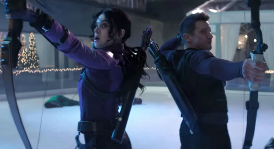 Kate Bishop and Clint Barton stand back to back while holding arrows in bows