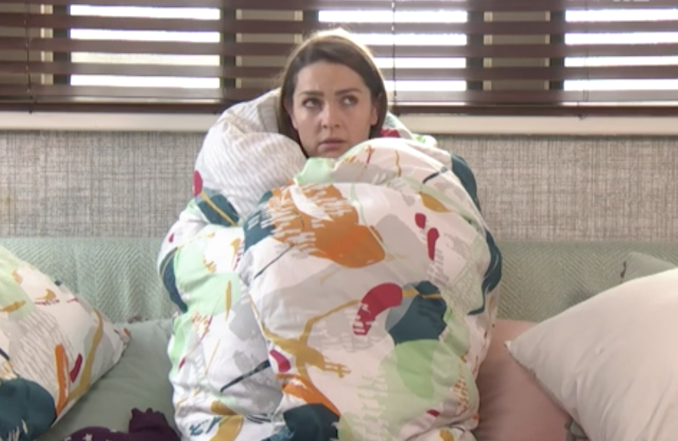 a woman with a large blanket wrapped around her