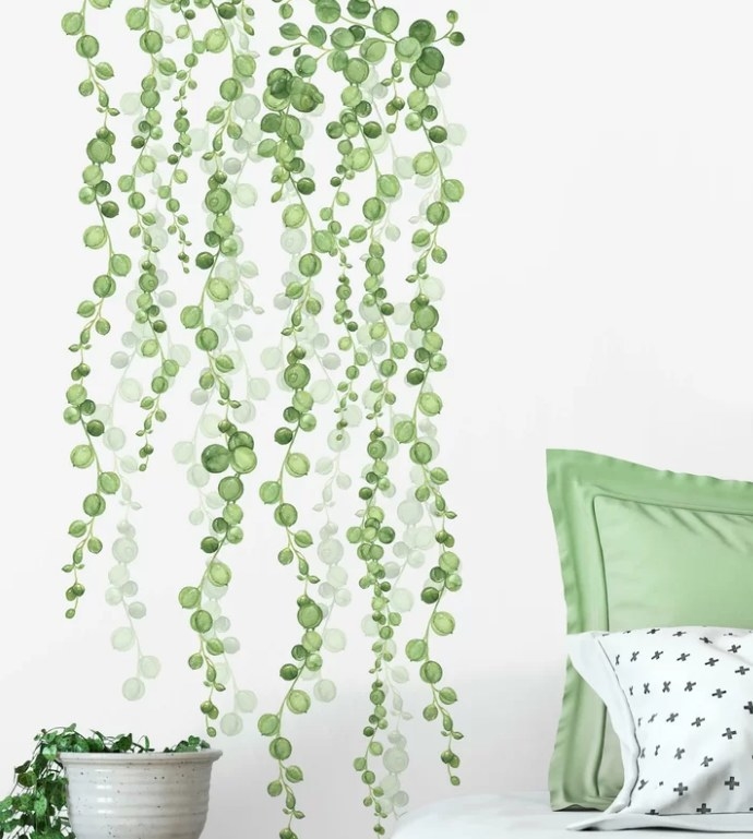 Green string of pearls wall decal on white wall.