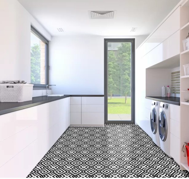 Black and white retro floor tiles in a white laundry room.