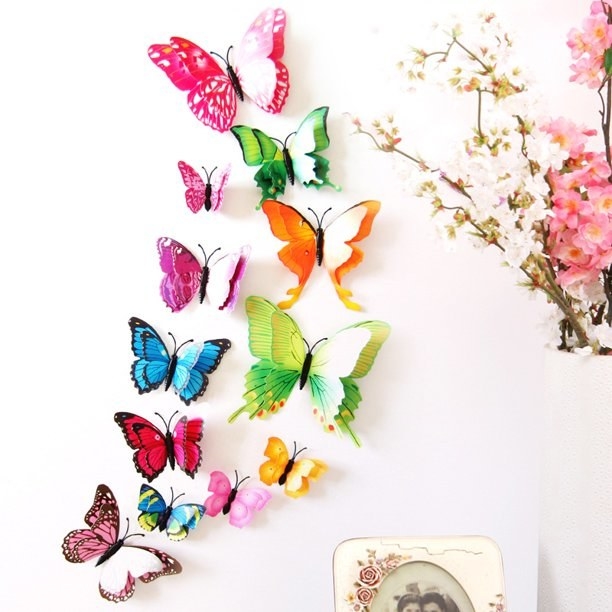 An image of a set of 12 3D butterfly wall decals mounted onto a wall