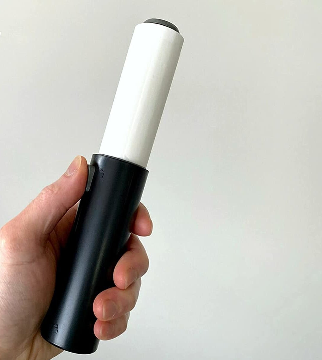 A person holding the lint roller