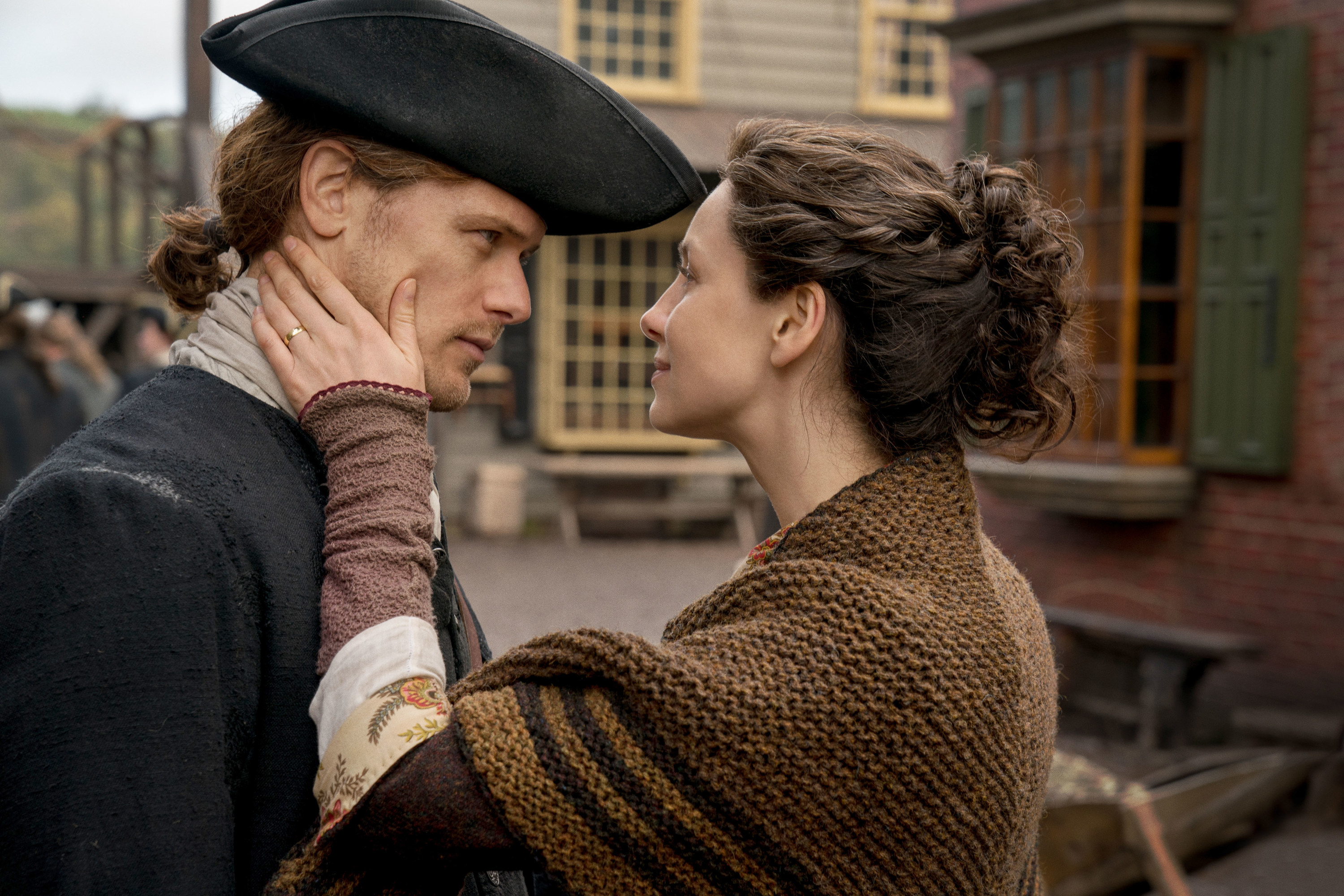 Claire Beauchamp Fraser holds the face of her husband, James