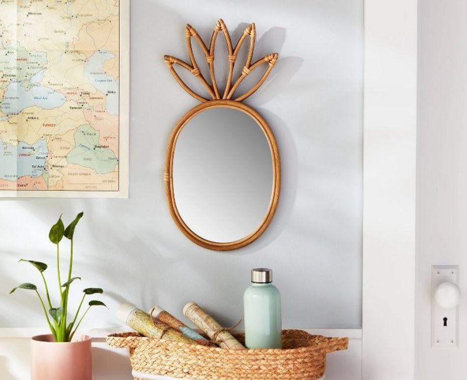 the pineapple shaped mirror on a wall