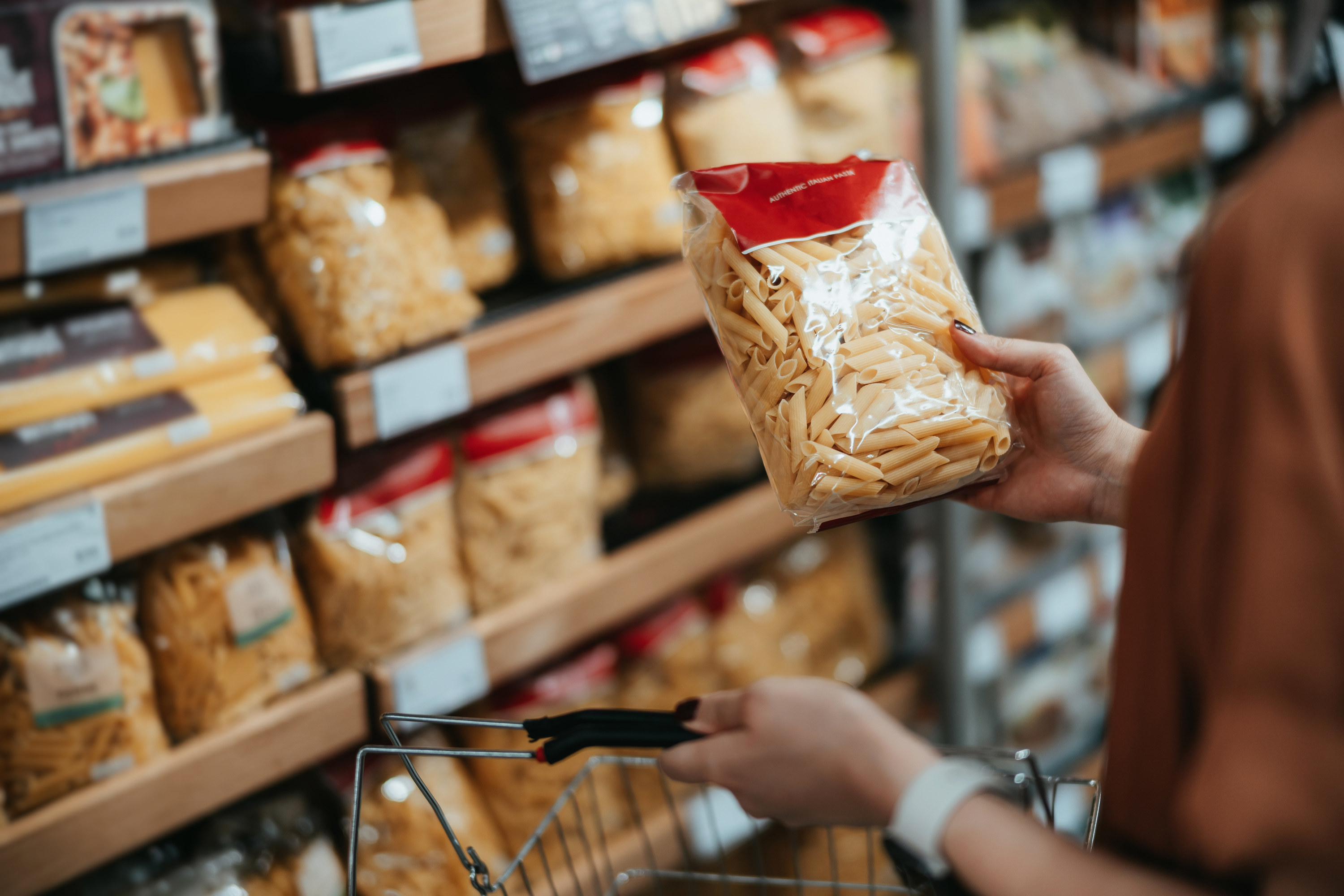 A person looking at pasta in a supermarket