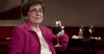 A woman drinking a glass of wine