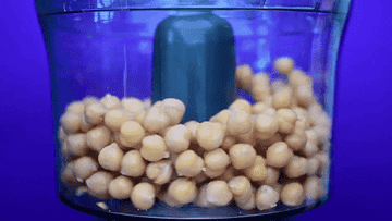 A food processor crushing chickpeas