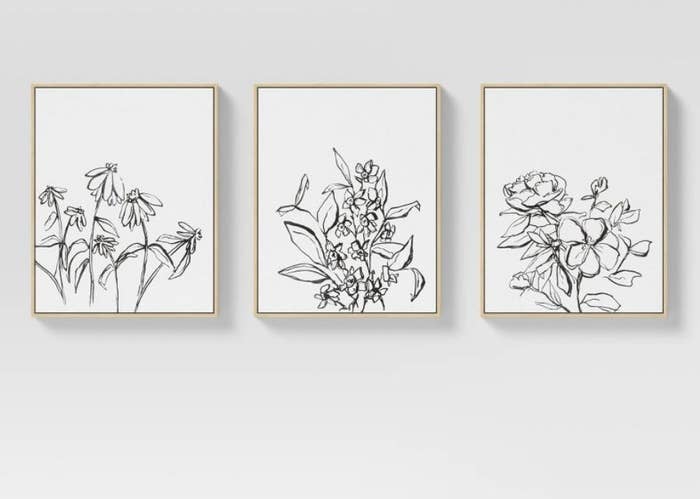3 canvases with floral drawings. 