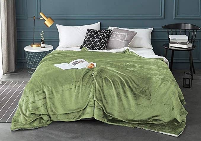 The blanket spread out on a bed in a bedroom