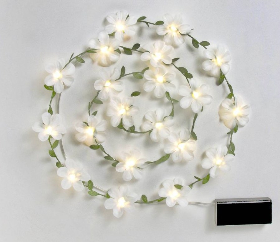 Floral string lights lit up in a coil