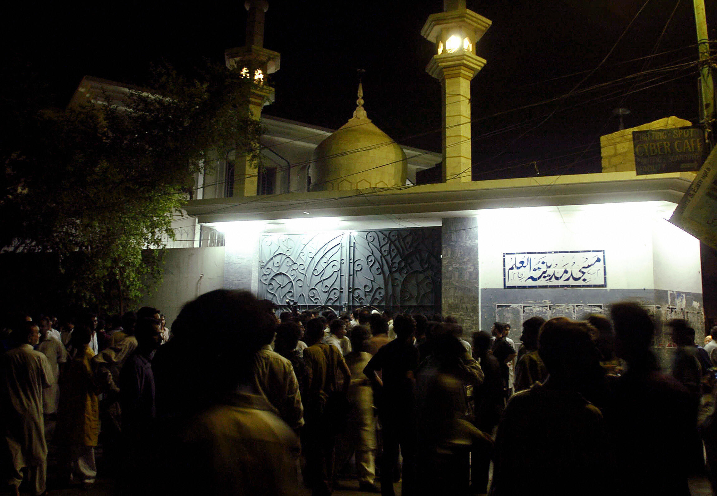 People mourn outside a mosque in the days following an explosion terrorist attack