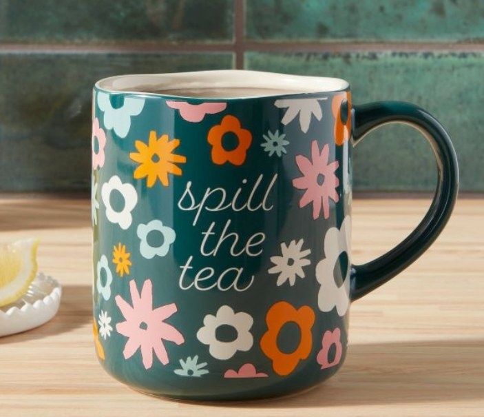 Floral mug will a &quot;spill the tea&quot; slogan