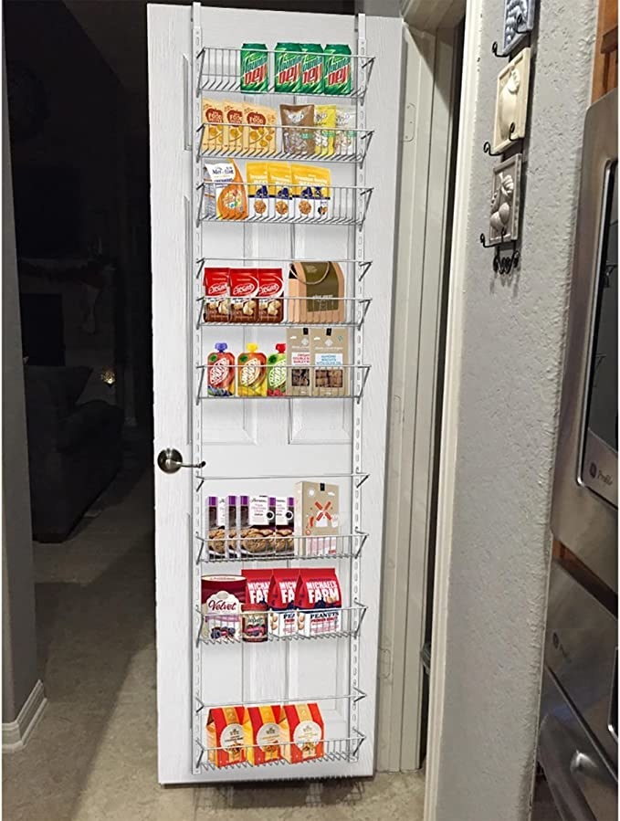 The storage shelf hanging on the inside of a pantry door