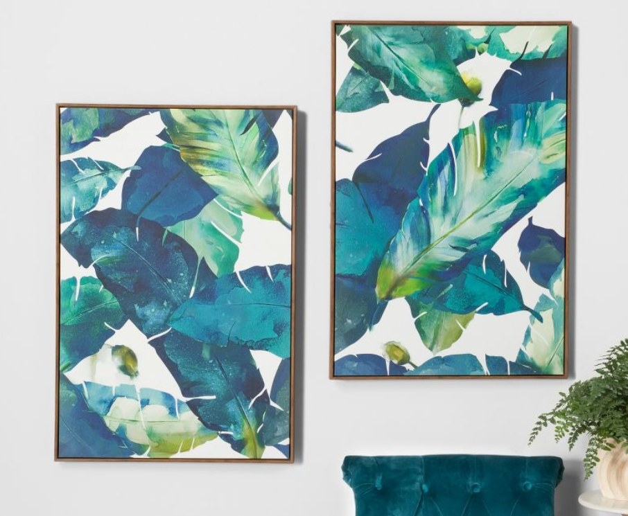 Palm leaf prints hanging on a wall