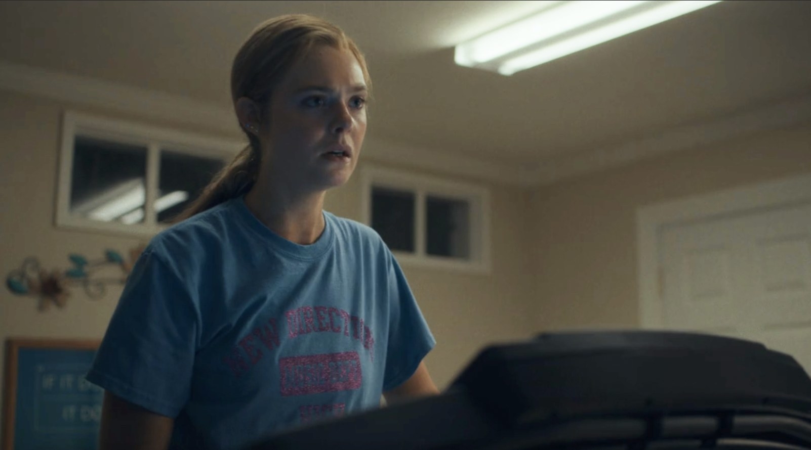 Michelle looks shocked on a treadmill wearing a shirt that says &quot;New Directions&quot;