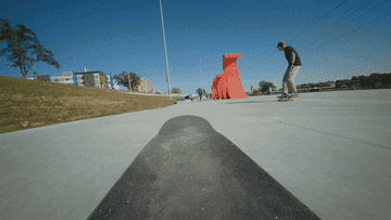 A young person skateboards through Lauridsen Skatepark