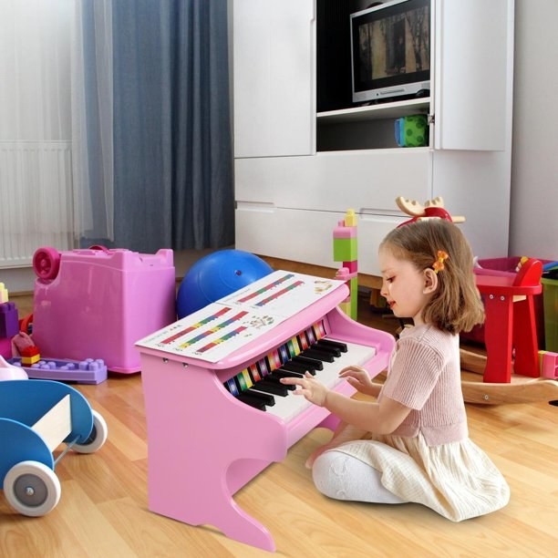 Child playing on small piano