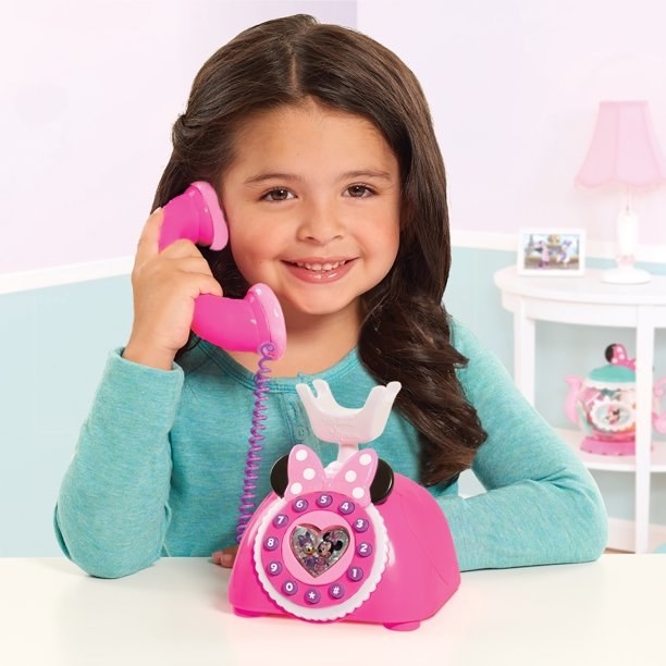 girl on Minnie Mouse phone