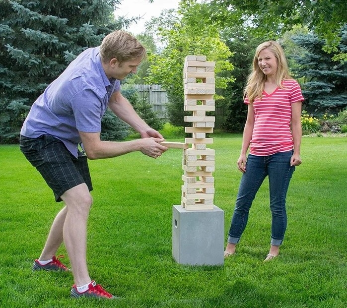 two people playing wood stacking game