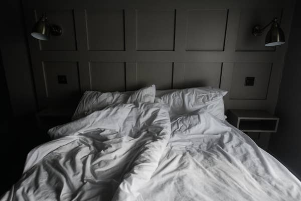 A bed with messy sheets