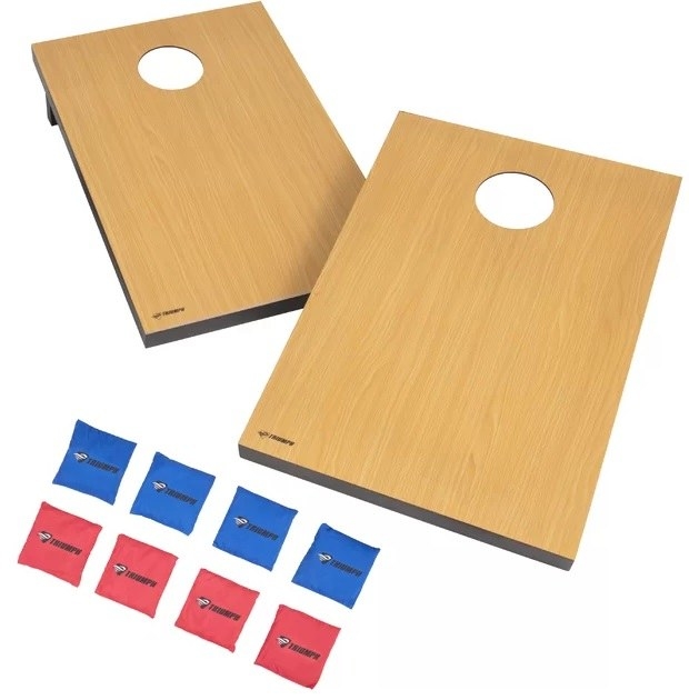 wood cornhole boards and red and white bean bags on white background