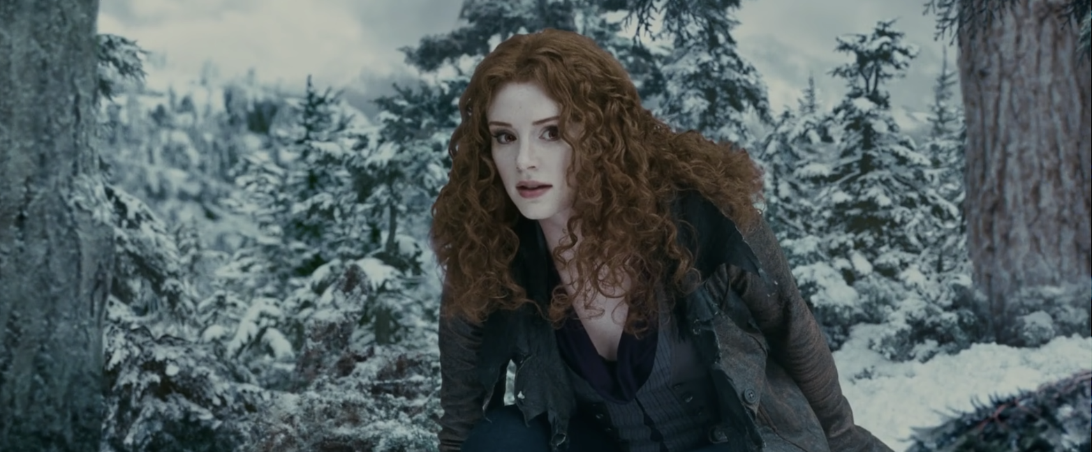 Victoria crouching through the snowy woods