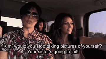 Kim Kardashian taking selfies in the car