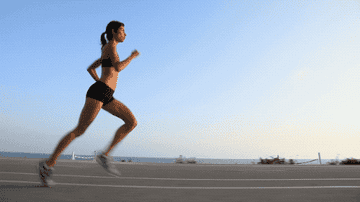 Long-distance runner running along a city street