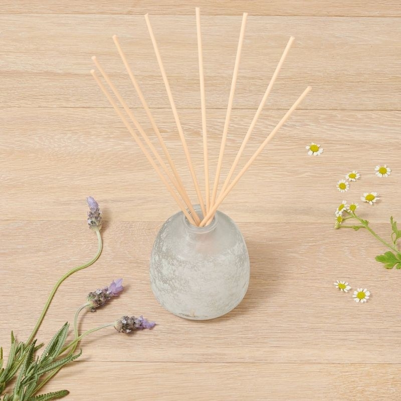 the diffuser with flowers next to it