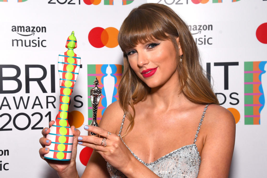 Taylor Swift posing with two Brit awards