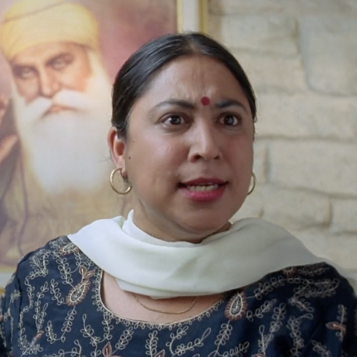 A close up of Mrs Bhamra; she has an angry expression on her face