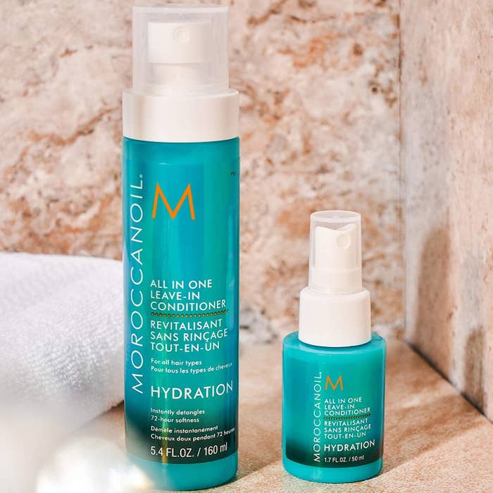Two bottles of Moroccanoil leave-in conditioner on a counter