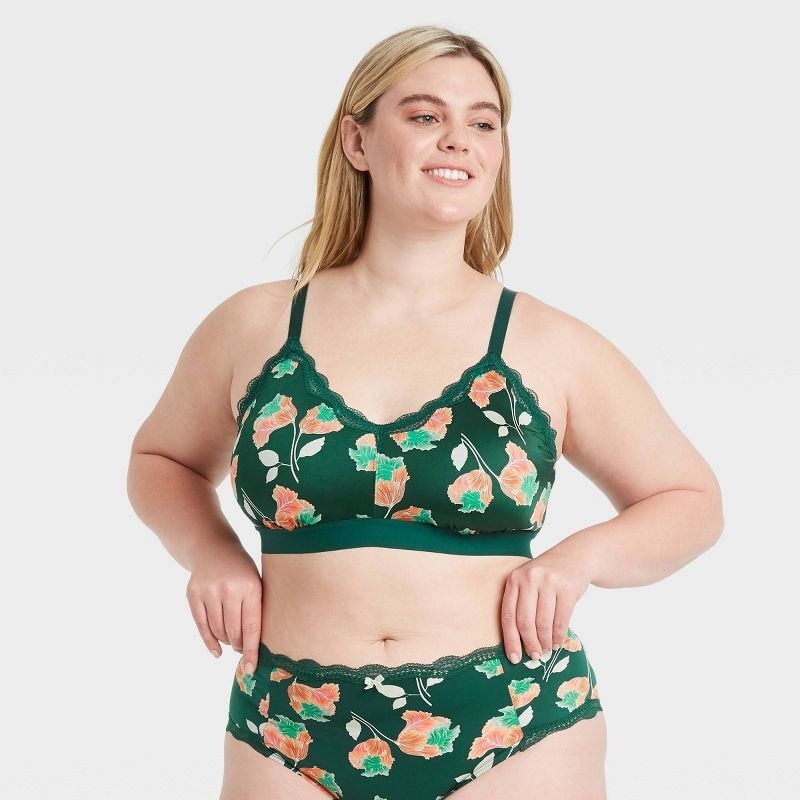 Model wearing green, white and orange matching bra and underwear set