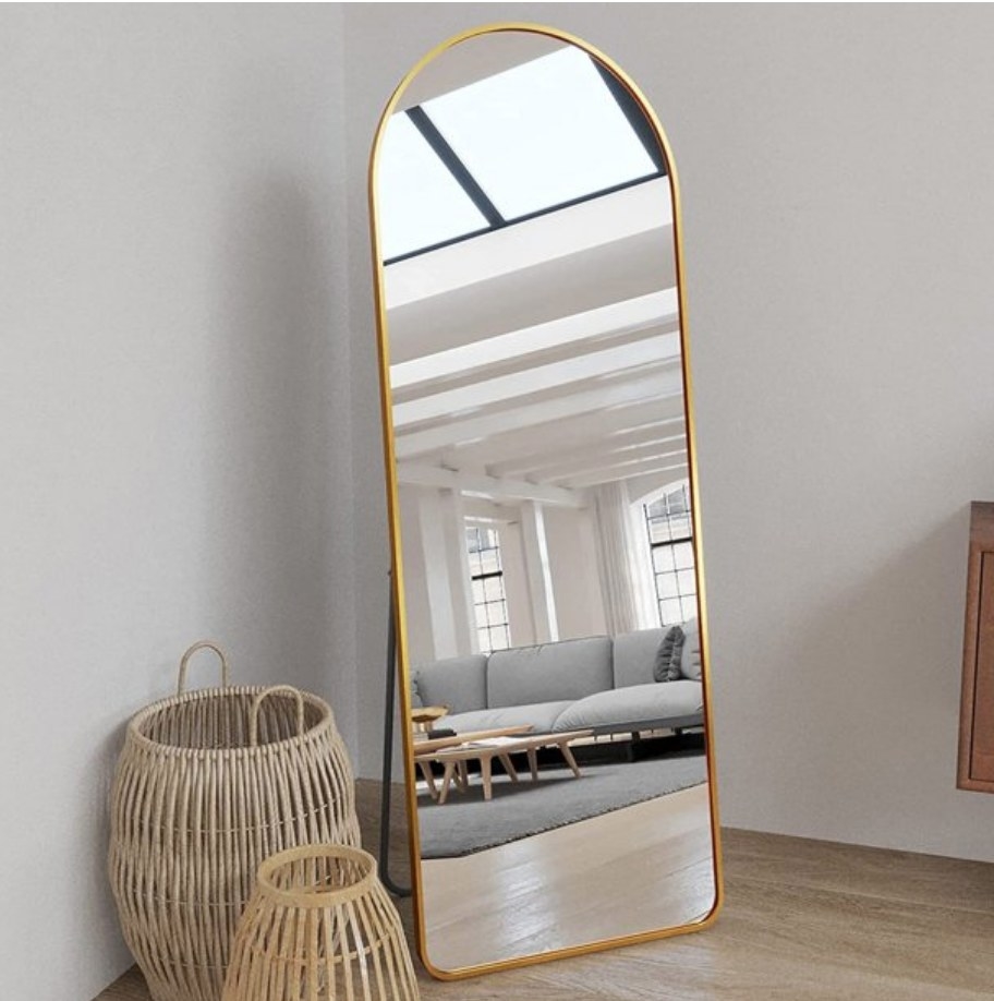 A gold full length floor mirror
