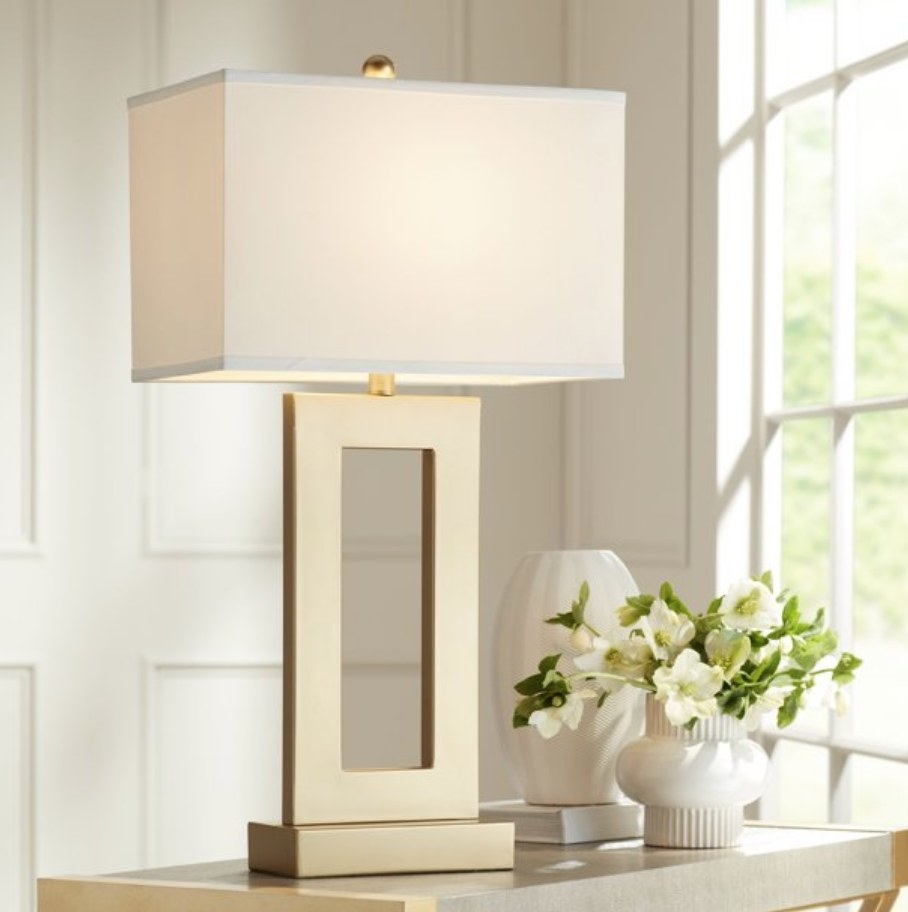 A gold open base rectangular table lamp