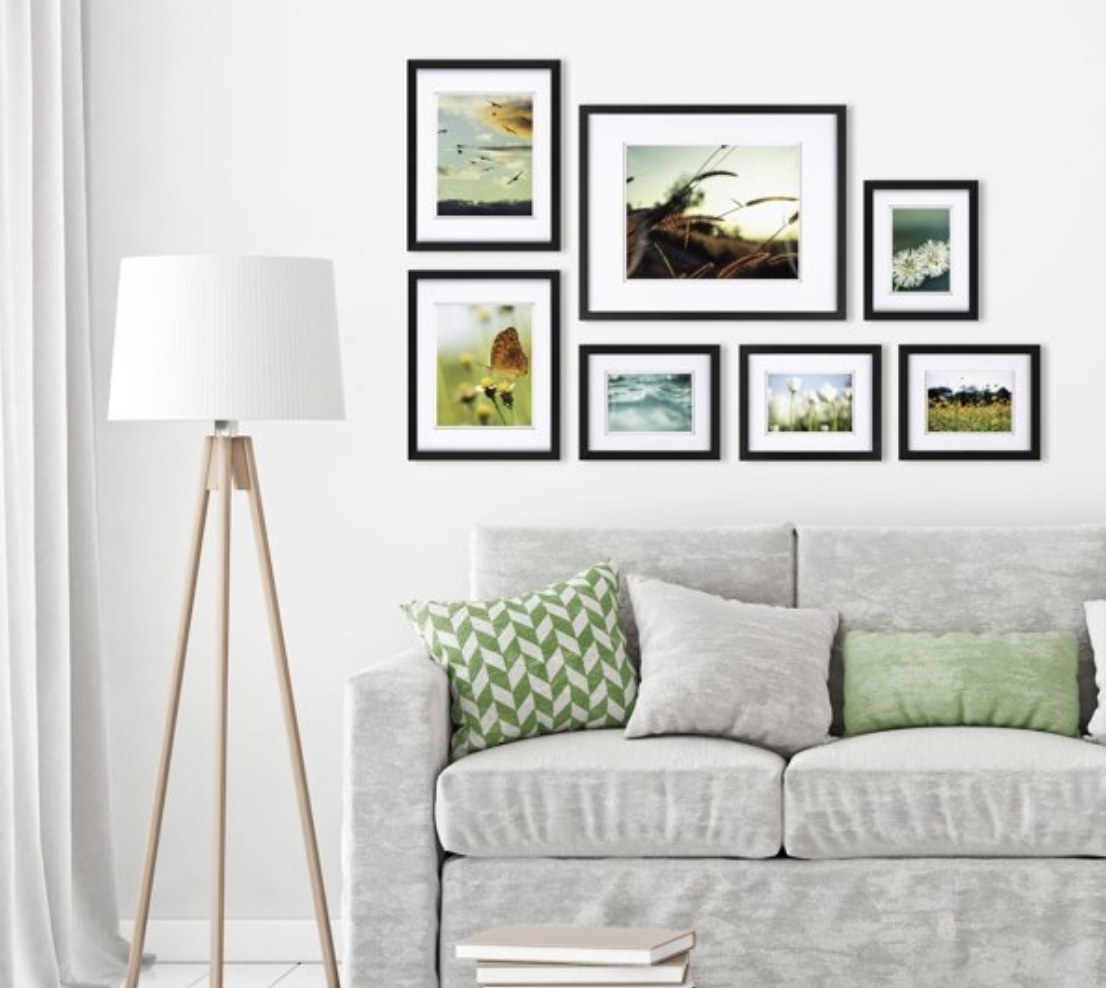 7 black gallery frames on a wall