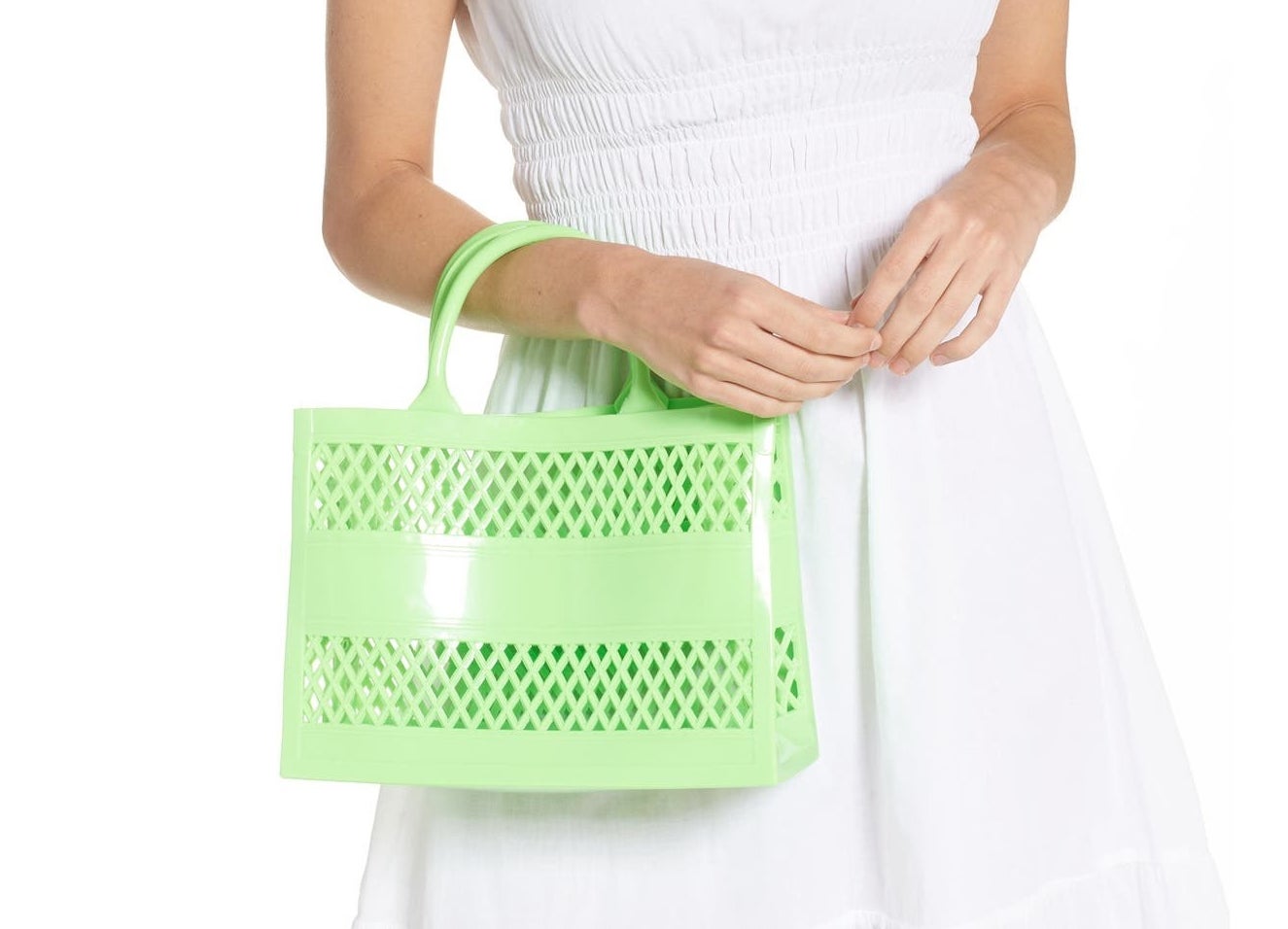 A woman holding the plastic tote with mesh sides