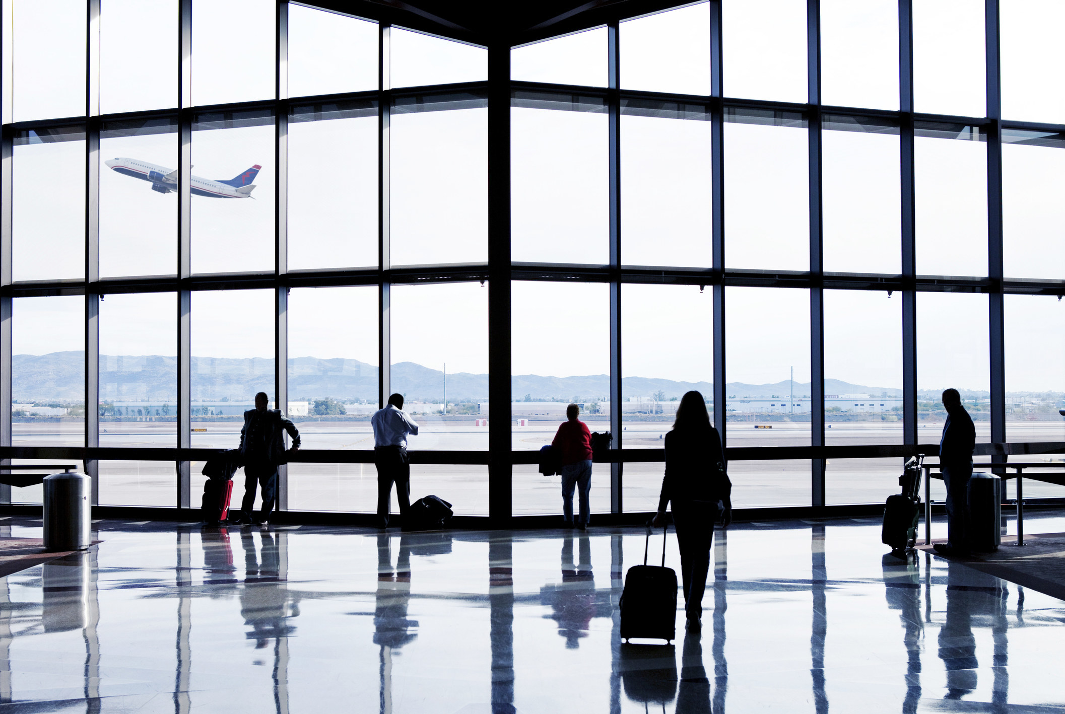 People with their luggage at the airport.