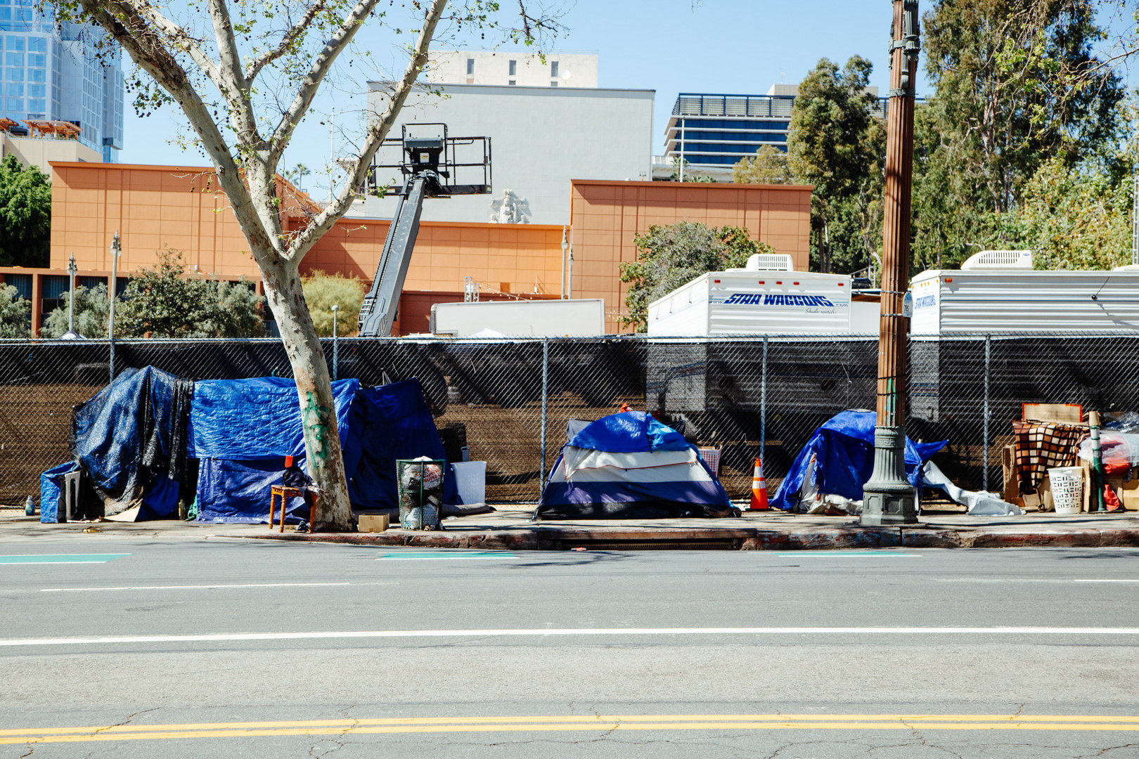 A number of tents on a city sidewalk